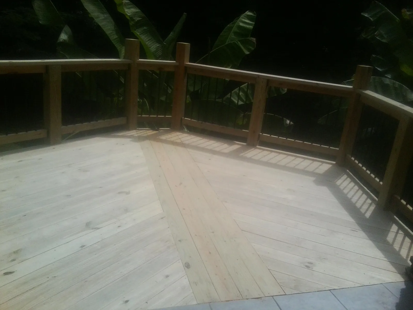New wood deck and railing built off the back of a home in Georgetown